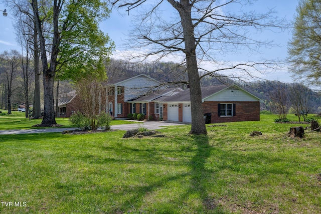204 Amity Dr, Bristol, TN 37620 - greek revival inspired property featuring a garage, a front yard, brick siding, and driveway