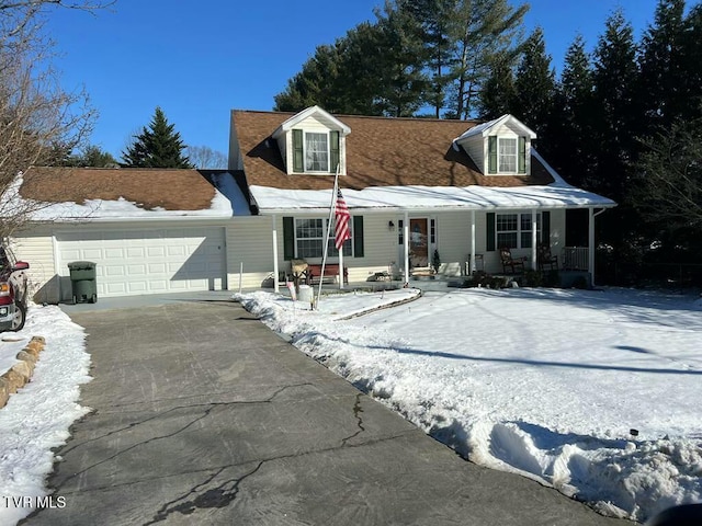 cape cod home with a garage and a porch