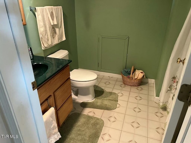 bathroom featuring toilet, vanity, and tile patterned floors