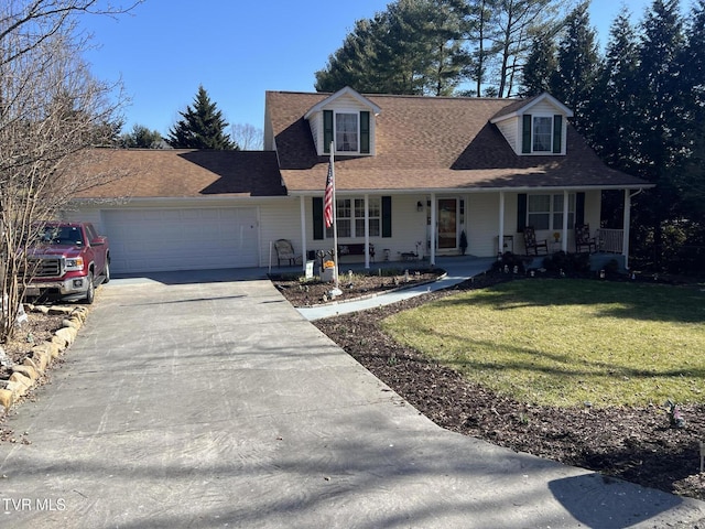 cape cod-style house featuring a shingled roof, covered porch, an attached garage, a front yard, and driveway