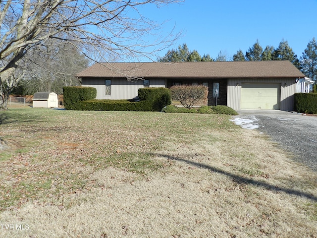 ranch-style house with a front yard and a garage