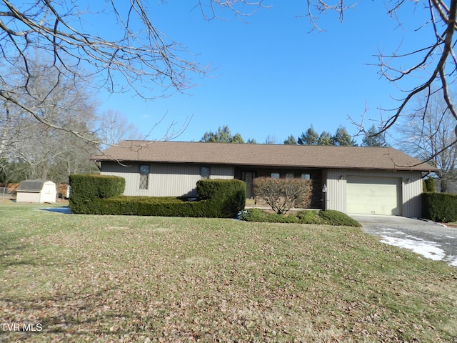 ranch-style home with a front lawn and a garage