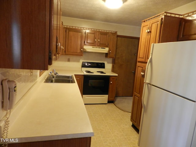 kitchen featuring white fridge, a textured ceiling, electric stove, and sink