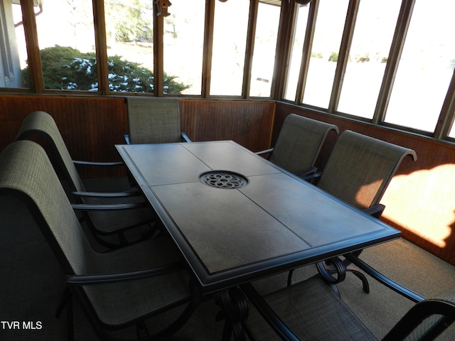 dining room featuring wooden walls