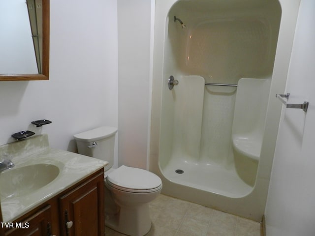 bathroom with vanity, walk in shower, and toilet