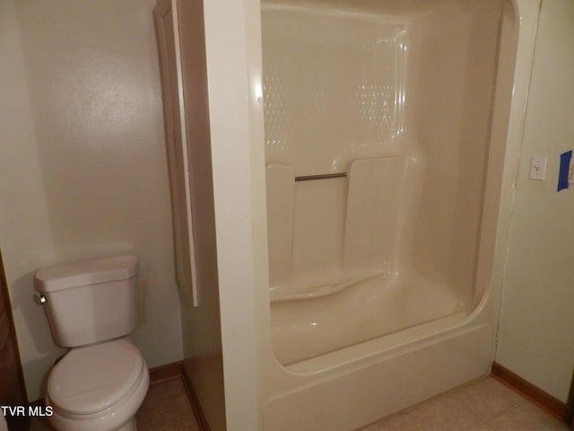 bathroom featuring toilet, washer / dryer, tile patterned flooring, and walk in shower