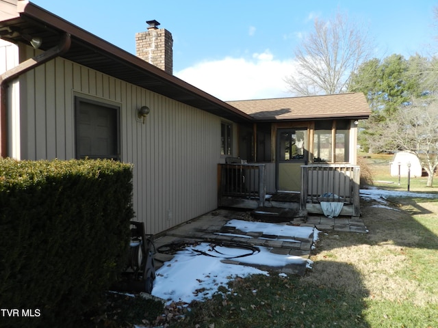 view of side of home with a lawn