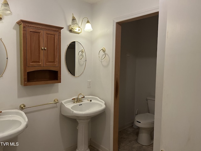 bathroom featuring sink, tile patterned floors, and toilet