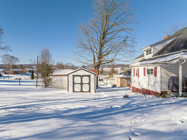 snowy yard with a storage unit