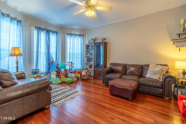 living room featuring hardwood / wood-style flooring, ornamental molding, and ceiling fan