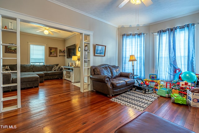 living room featuring dark wood-type flooring, crown molding, and a wealth of natural light