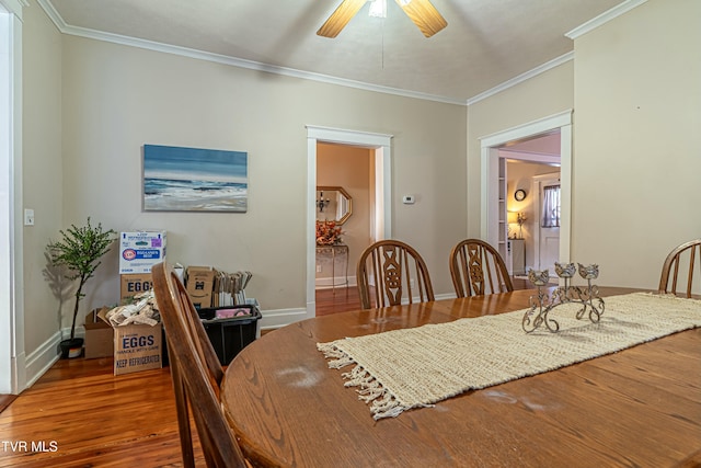 dining space with ceiling fan, ornamental molding, and hardwood / wood-style floors