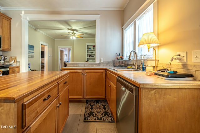 kitchen with ornamental molding, butcher block counters, dishwasher, and sink