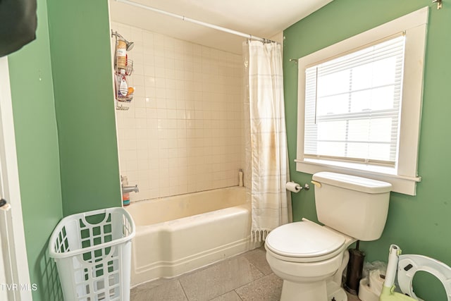 bathroom with shower / tub combo, tile patterned floors, and toilet