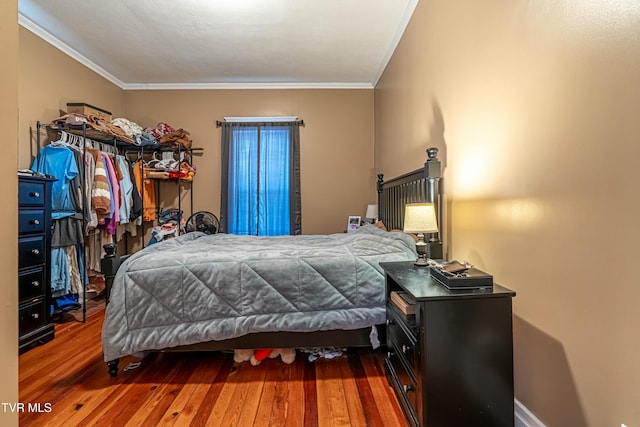 bedroom featuring crown molding and hardwood / wood-style floors