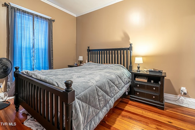 bedroom with hardwood / wood-style flooring and ornamental molding