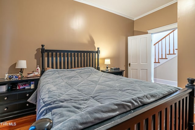 bedroom with hardwood / wood-style floors and crown molding