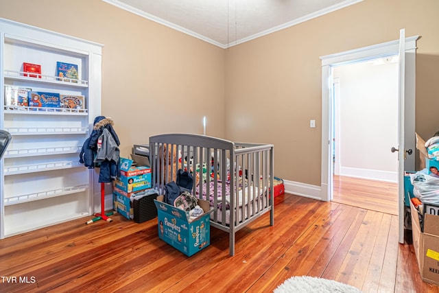 bedroom with hardwood / wood-style flooring and ornamental molding