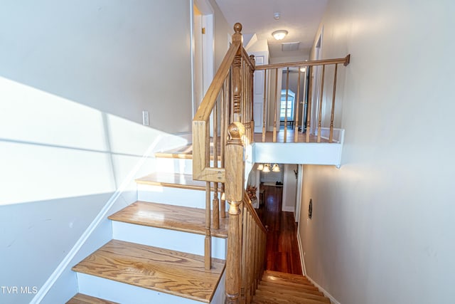 stairway with hardwood / wood-style floors