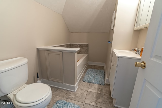 bathroom with vaulted ceiling, a tub, a textured ceiling, and toilet