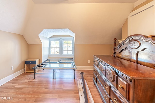 interior space with vaulted ceiling and light wood-type flooring