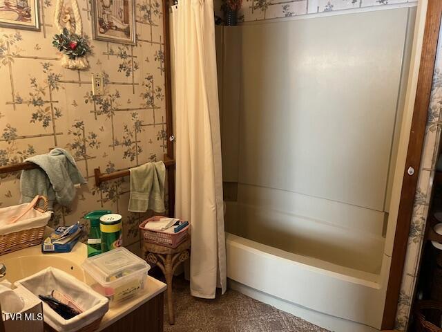 bathroom with shower / bath combo with shower curtain