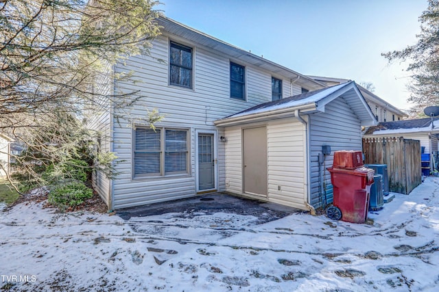 snow covered house with cooling unit