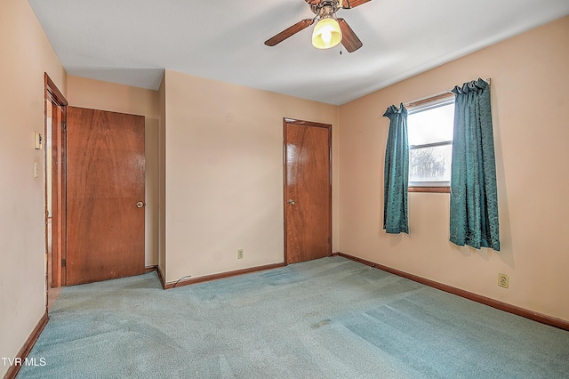 unfurnished bedroom featuring ceiling fan and light carpet