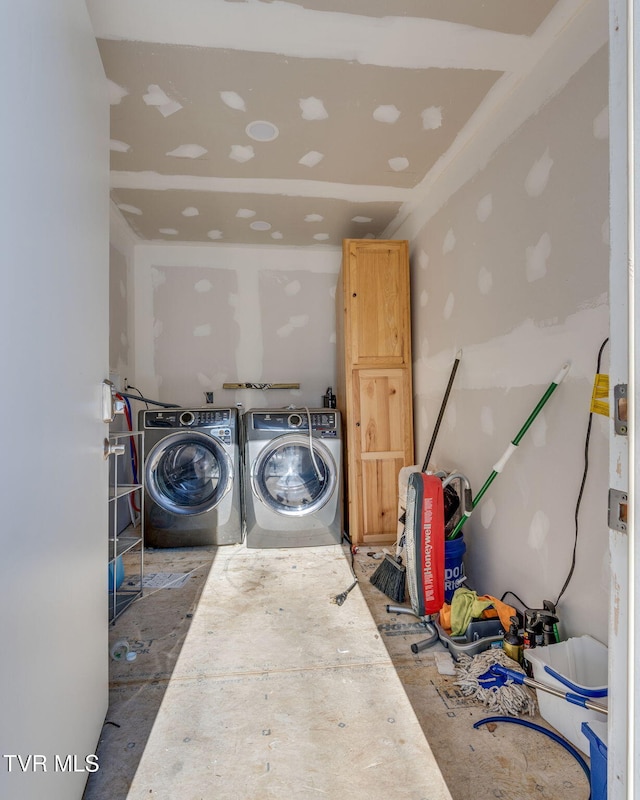 clothes washing area with washing machine and dryer