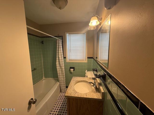 bathroom with vanity and shower / tub combo with curtain