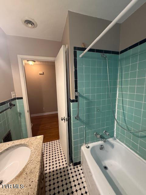 bathroom featuring shower / bathtub combination and vanity