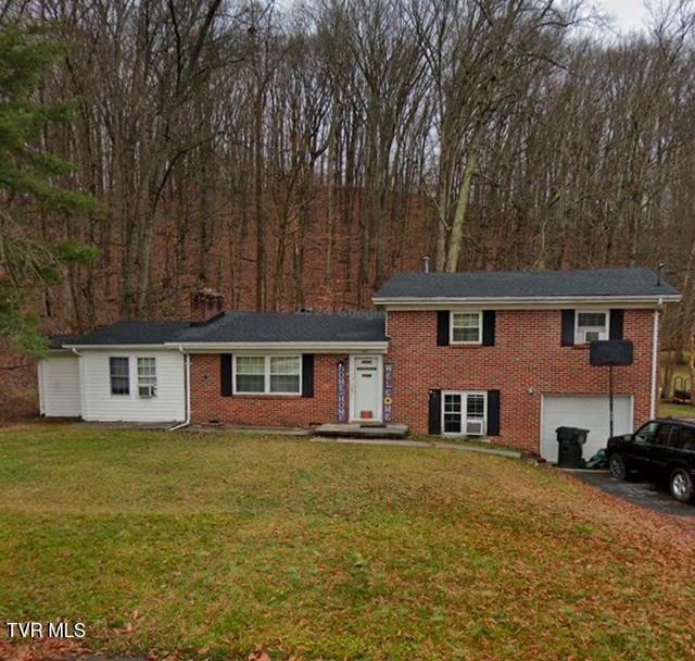 view of front of property with a front lawn and a garage