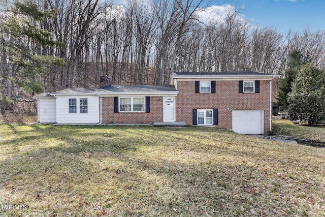 split level home with a garage, brick siding, a chimney, and a front lawn