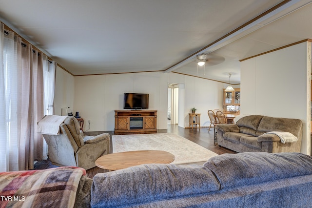 living room featuring ceiling fan, vaulted ceiling with beams, wood-type flooring, and ornamental molding