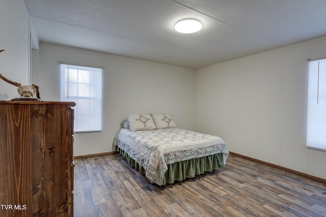 bedroom with wood-type flooring and a textured ceiling