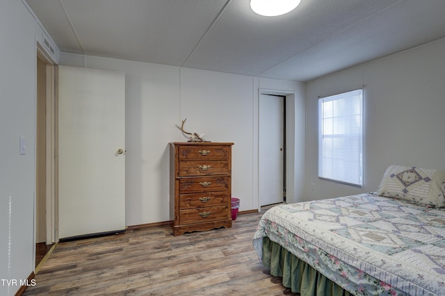 bedroom featuring a textured ceiling and hardwood / wood-style floors