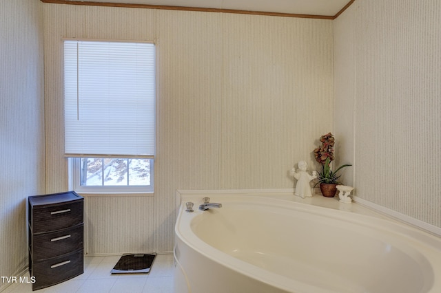 bathroom with a tub to relax in and tile patterned floors