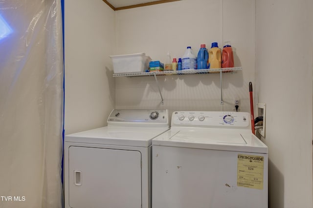 laundry area with separate washer and dryer and ornamental molding