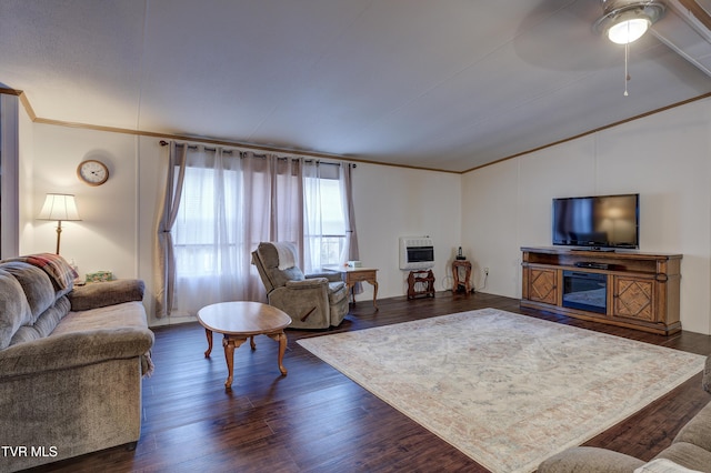 living room featuring dark wood-type flooring, ornamental molding, heating unit, and ceiling fan