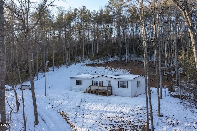 snow covered property featuring a deck