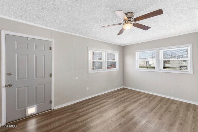 unfurnished room with ceiling fan, a textured ceiling, and hardwood / wood-style flooring