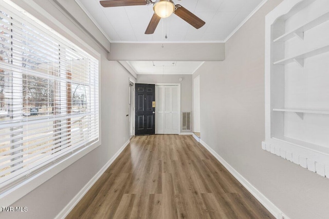 hall with dark hardwood / wood-style flooring and ornamental molding