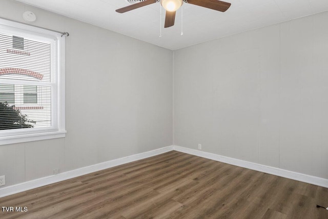 empty room with ceiling fan and dark wood-type flooring