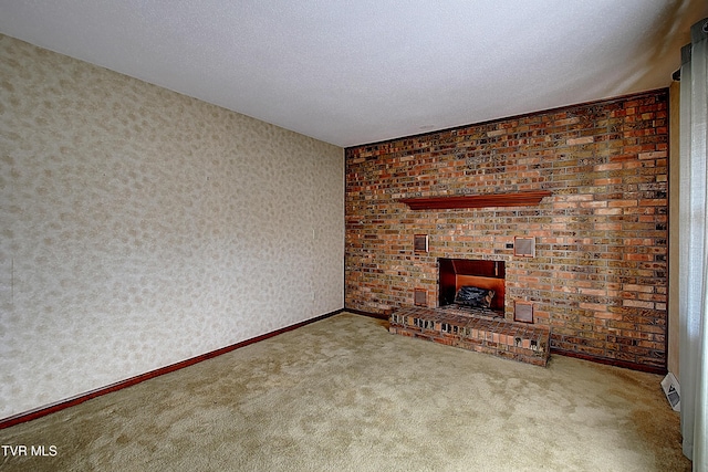 unfurnished living room with carpet, a textured ceiling, and a fireplace