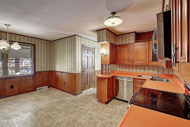 kitchen with hanging light fixtures, sink, a chandelier, and appliances with stainless steel finishes