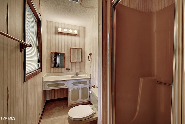 bathroom featuring vanity, toilet, and a textured ceiling