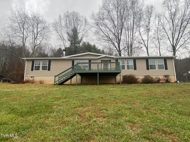 back of property with a deck and a yard