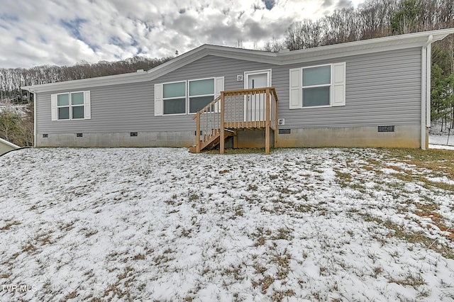 view of snow covered rear of property