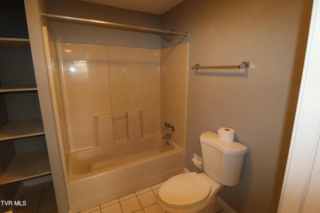 bathroom with toilet, tile patterned floors, and  shower combination