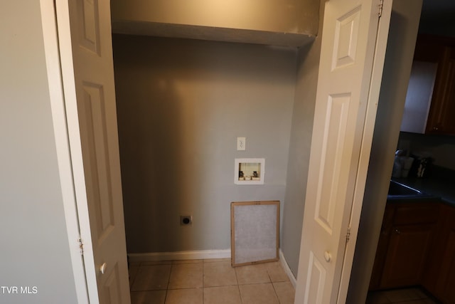 laundry area with light tile patterned flooring, hookup for a washing machine, and electric dryer hookup